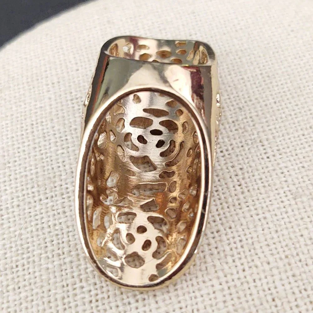 Long, open scroll design gold ring